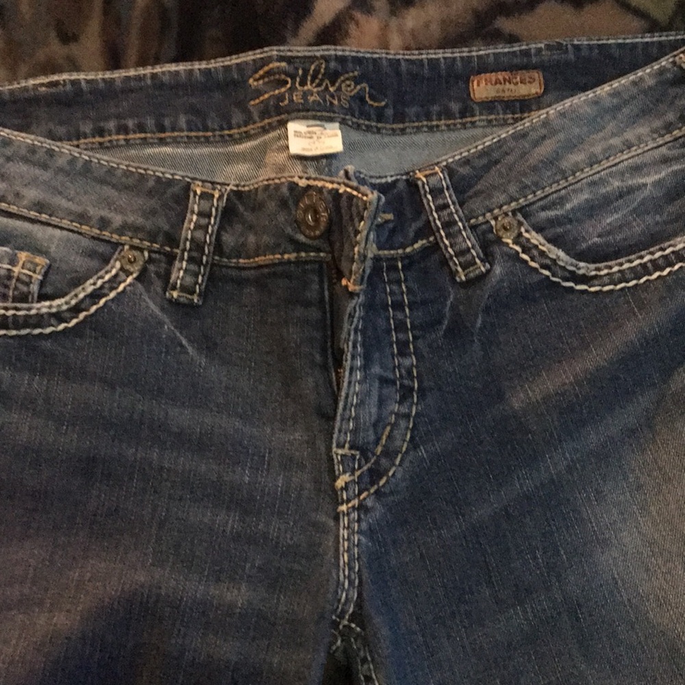 One pair of slightly loved silver brand jeans.